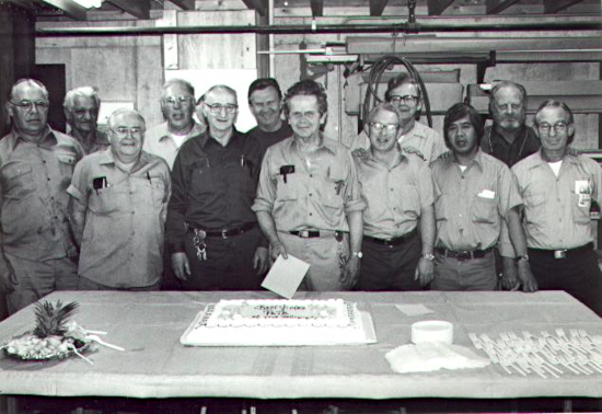My Dad flanked by eleven men, fellow employees of the community college where he worked, at his retirement party.